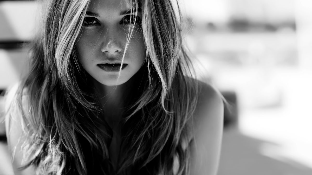 Black and white portrait of a female creator with long hair