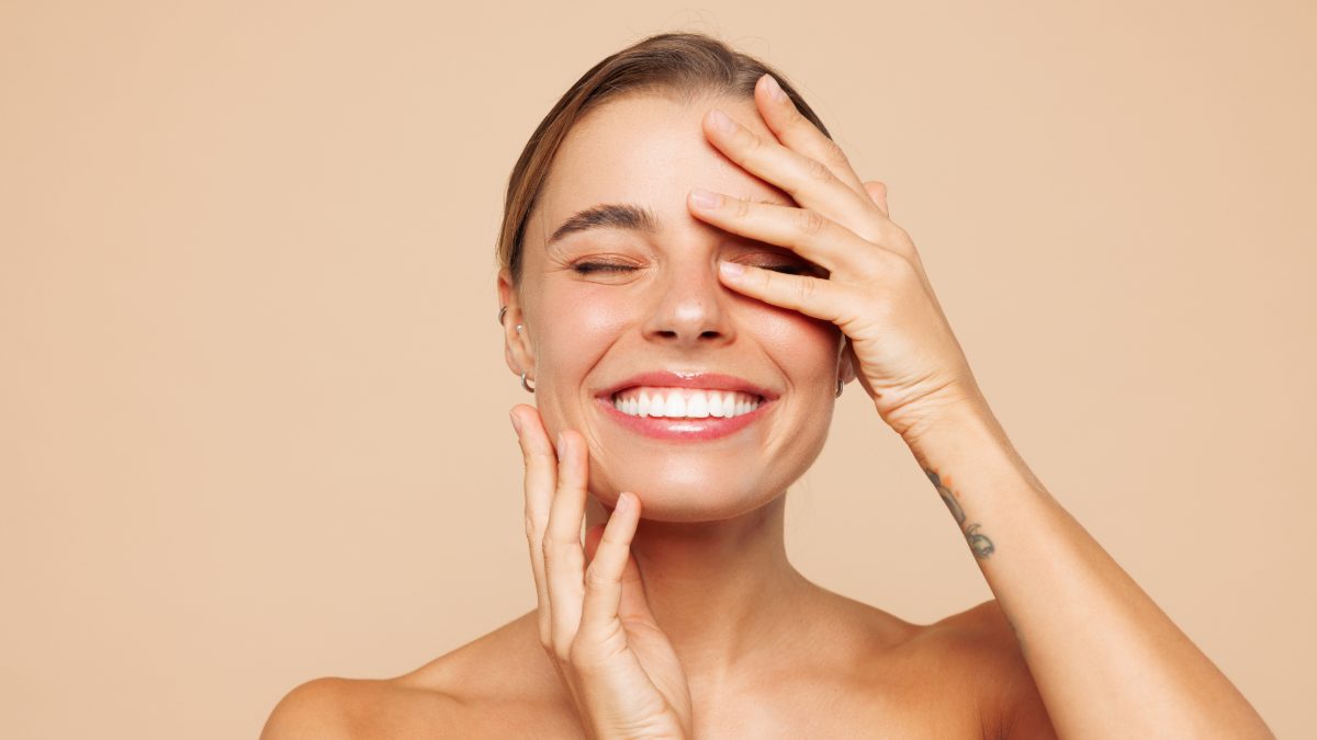 Female creator laughing with a hand over one eye