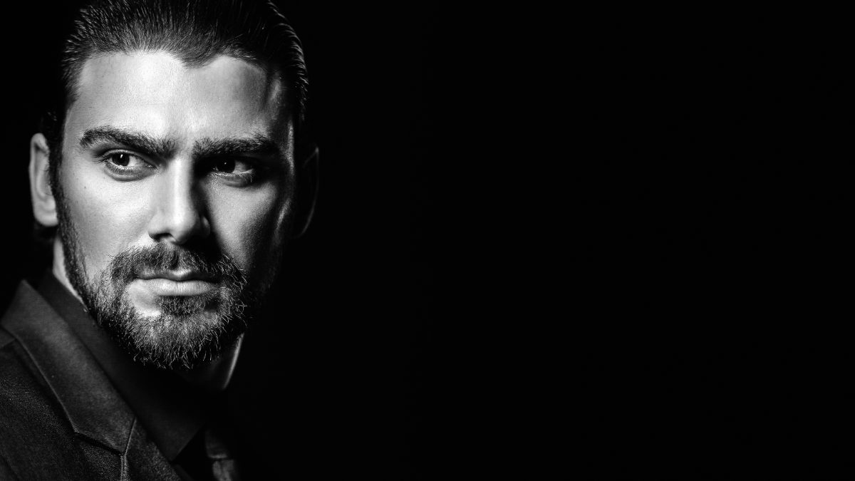 Male creator with a beard in dramatic low light