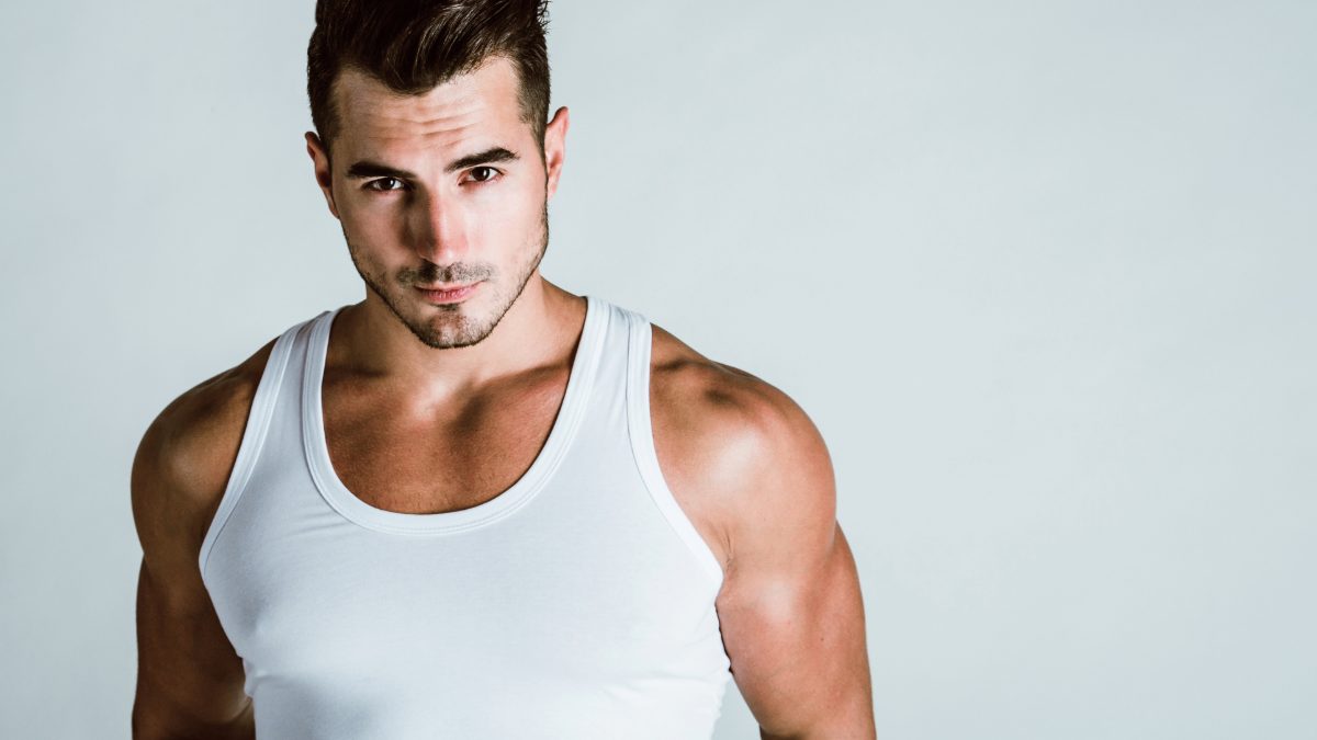Athletic male creator in a white tank top