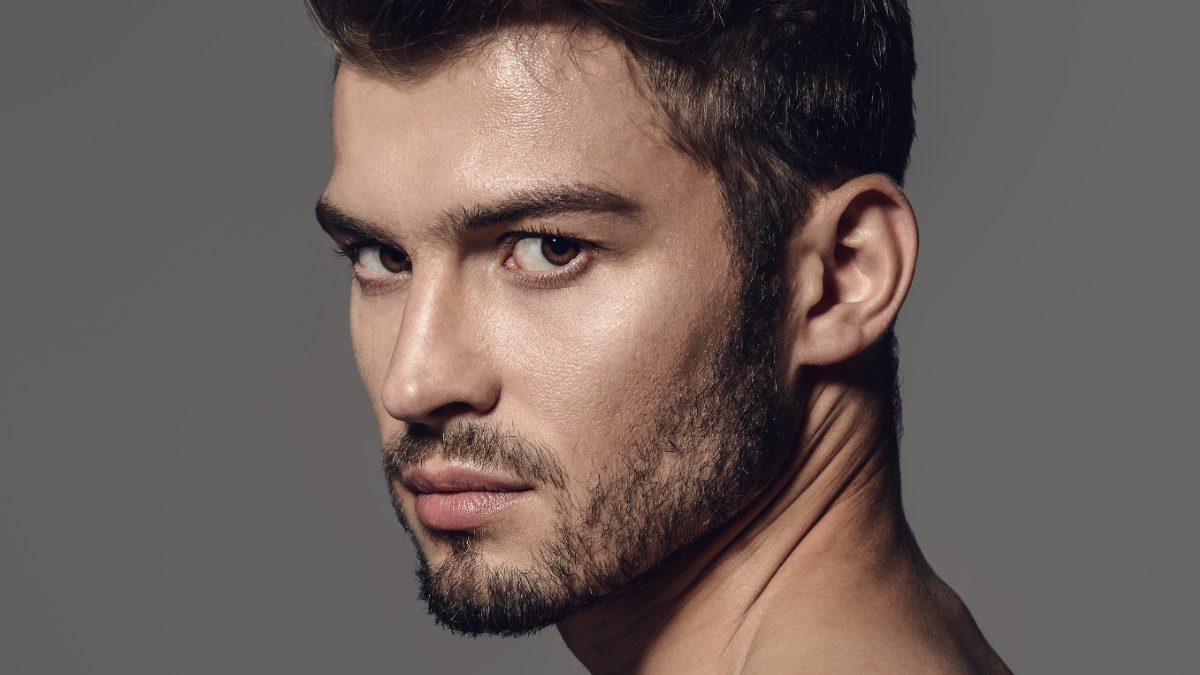 Male creator portrait against a grey background